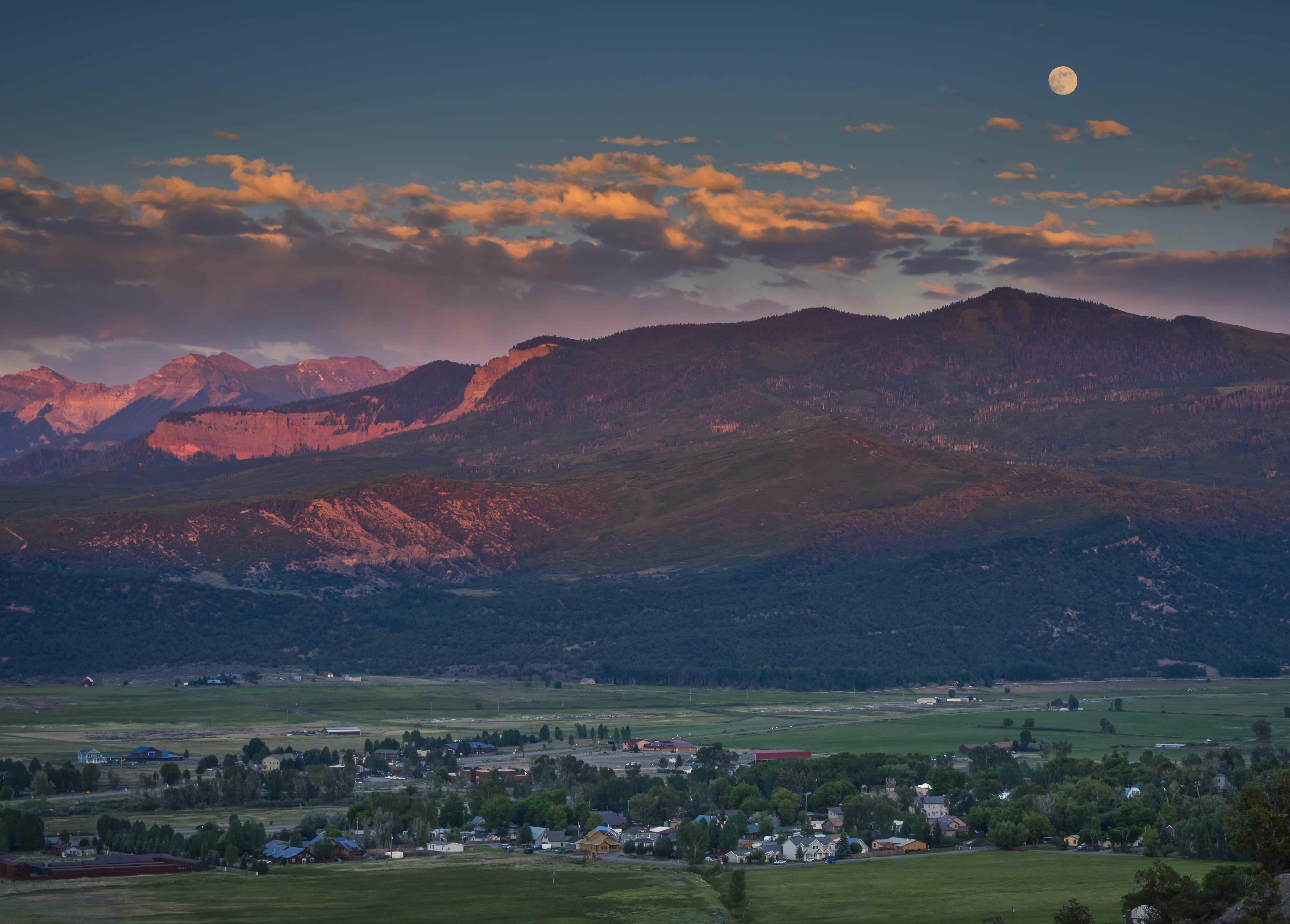 Dusk Valley view with moon by G. Ratcliff